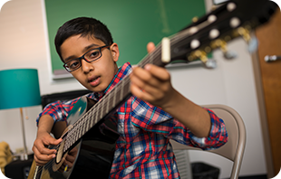Student enjoys the guitar